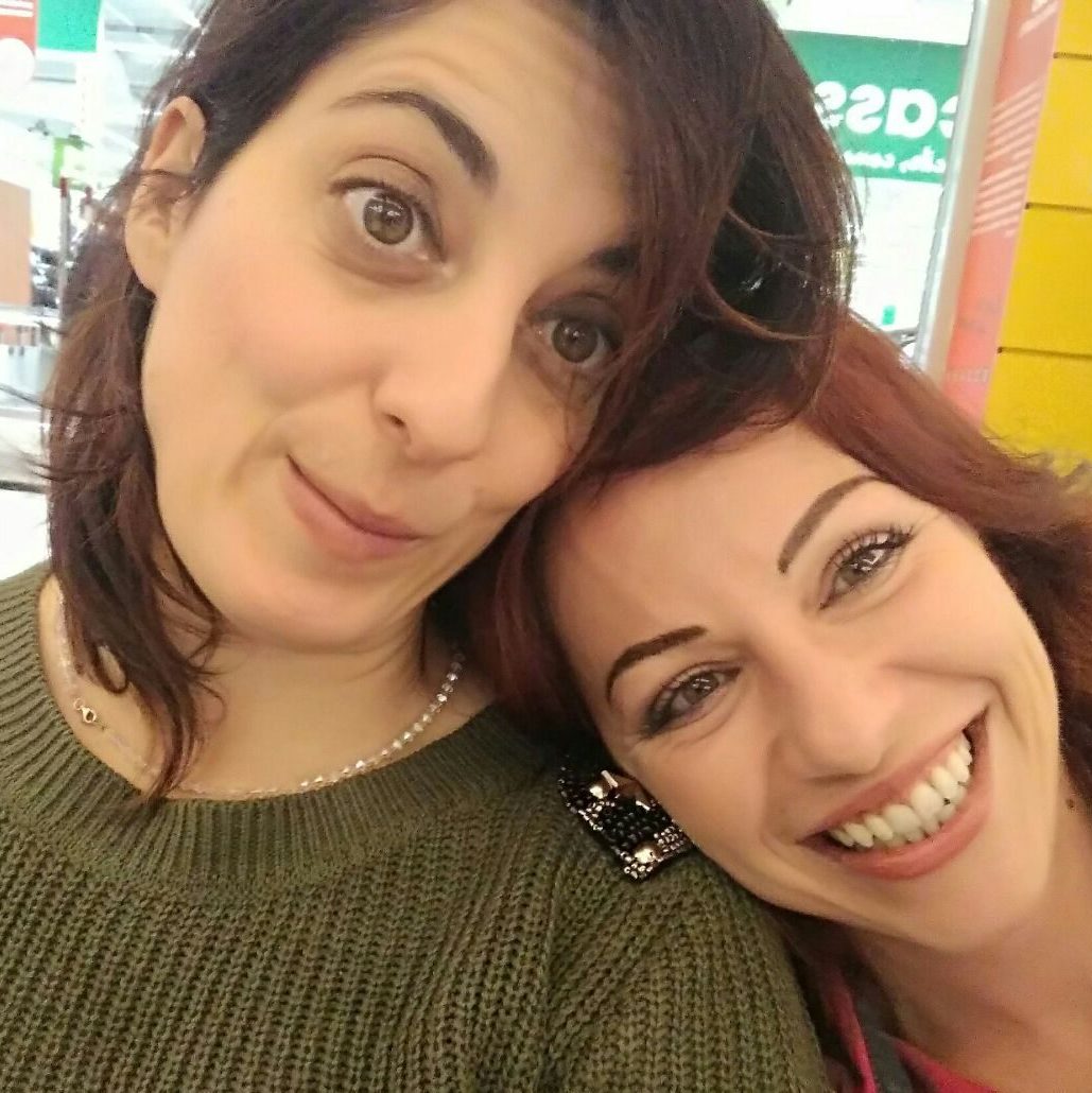 Two friends reunited after years, smiling and sharing a moment of genuine connection