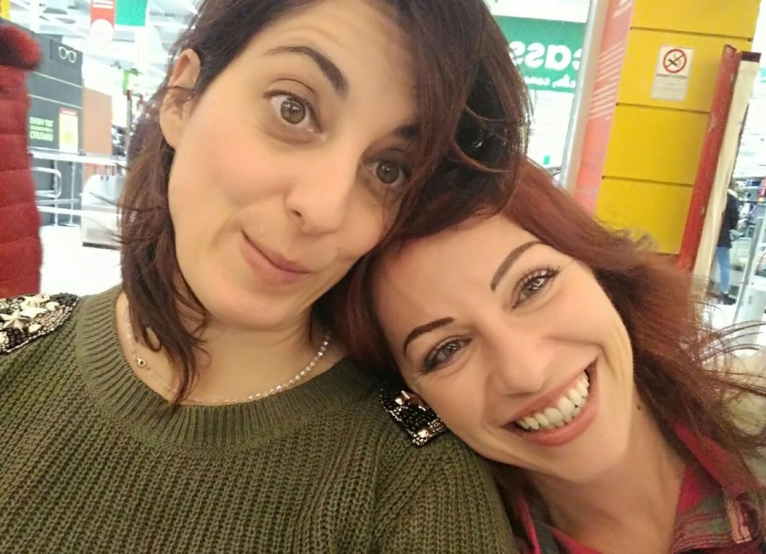 Two friends reunited after years, smiling and sharing a moment of genuine connection