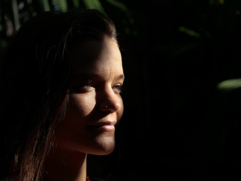 Woman standing in nature, present and grounded in a forest setting