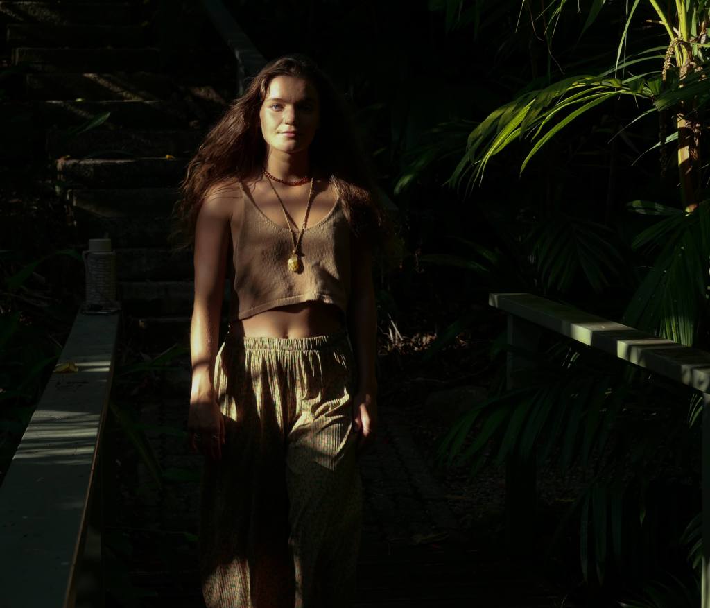 Woman moving through the forest, exploring and interacting with nature