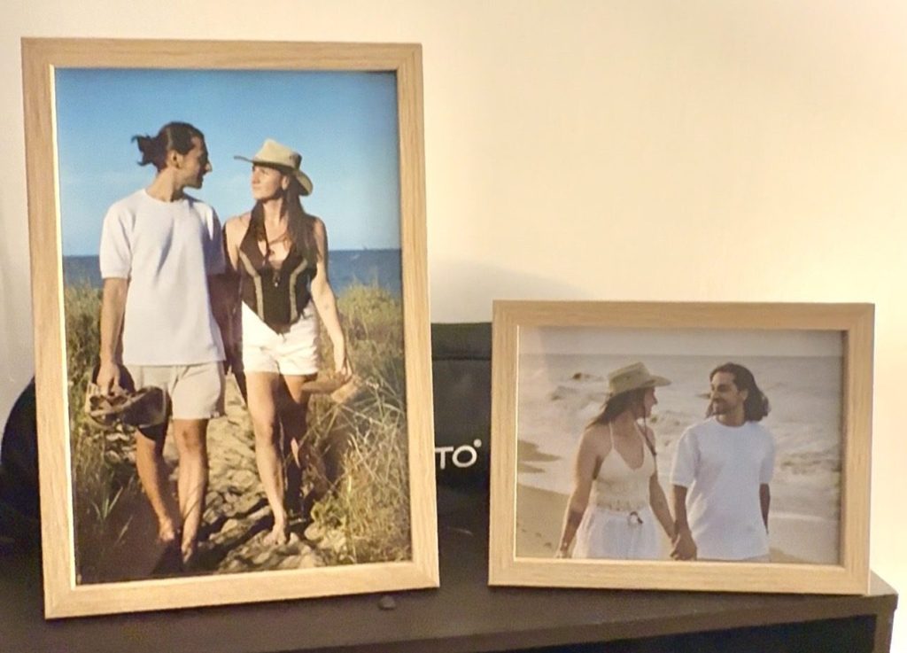 Two framed photographs from a couple session displayed in their home after the photo shoot.